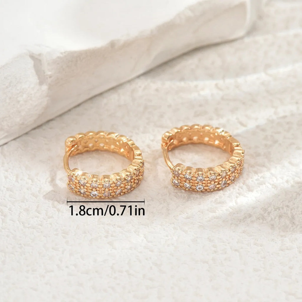 Copper geometry pattern ear studs with round, dot, and ring design elements.
