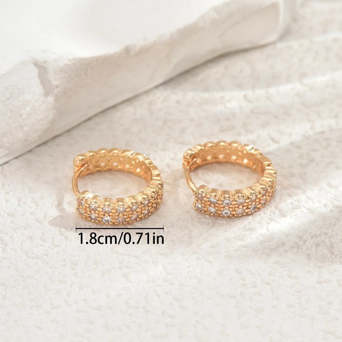 Copper geometry pattern ear studs with round, dot, and ring design elements.