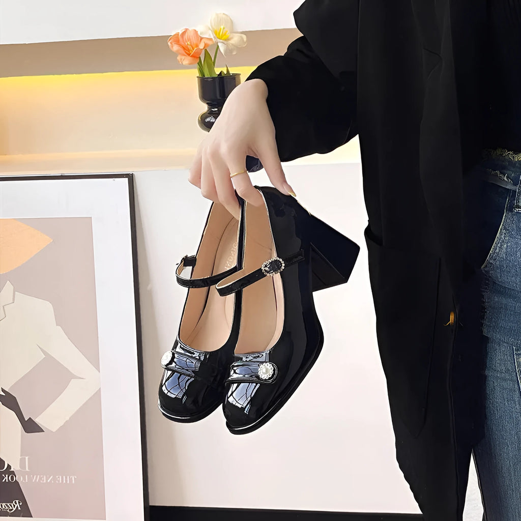 Women's black patent leather chunky heel shoes with round toe and buckle, shown in a larger size.