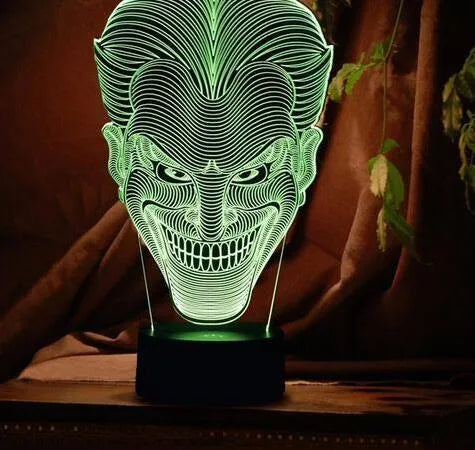 3D acrylic LED table lamp with USB cable and remote control on a desk