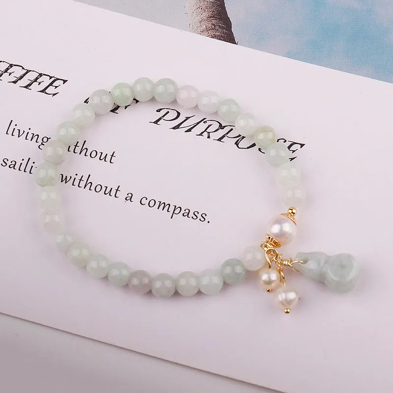 Emerald jade bracelet with hand-carved gourd design in traditional Chinese style