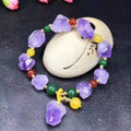Natural shaped amethyst bead bracelet with a fu character charm on a white background
