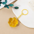 Cat's paw shaped keychain pendant made from a natural crystal gemstone on a keyring.