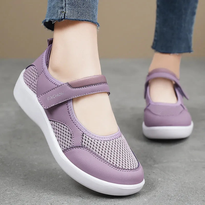 Women's low-top cloth shoes with mesh upper and Velcro strap in grey.