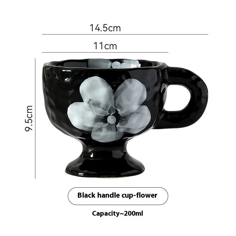 Hand-pinched irregular shaped solid colour ceramic mug on a table, showing its unique form and modern simplicity design.