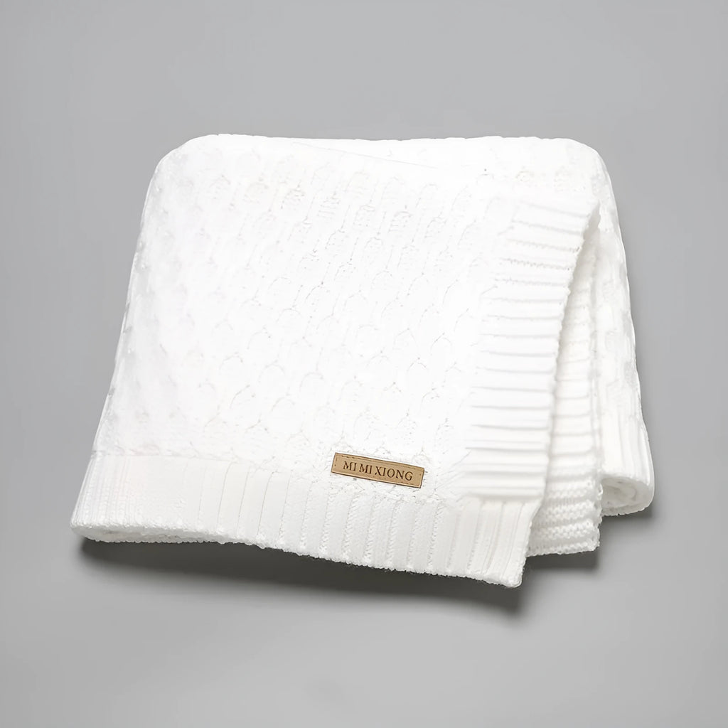 Solid colour acrylic infant hug blanket with three-dimensional lines, shown in a selection of colours.