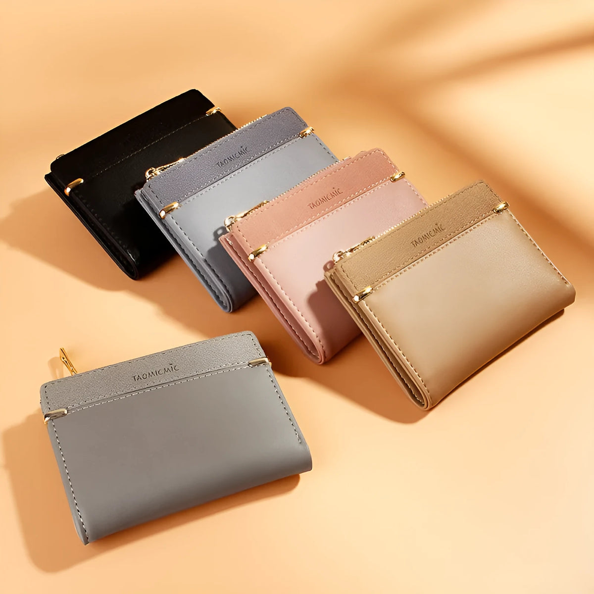 Women's black PU leather bifold wallet open to show card slots, zipper compartment, and change pocket.