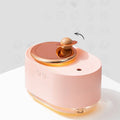 Green rotating planet-shaped USB humidifier with night light on a table