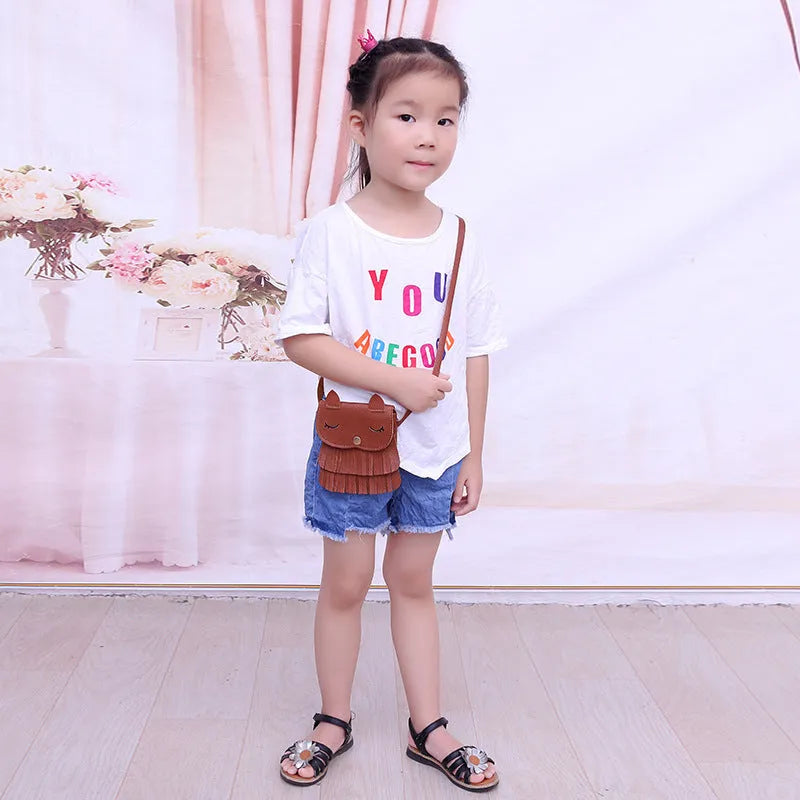 Small girls crossbody bag in PU with fox and tassel design, shown in black, brown, grey, pink, and orange