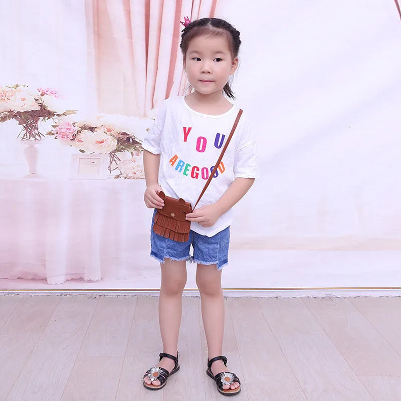 Small girls crossbody bag in PU with fox and tassel design, shown in black, brown, grey, pink, and orange