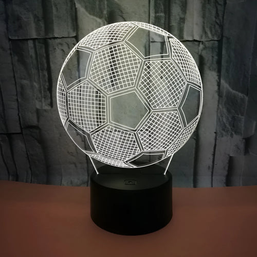3D football shaped LED night light showing multiple colour options on a dark surface.