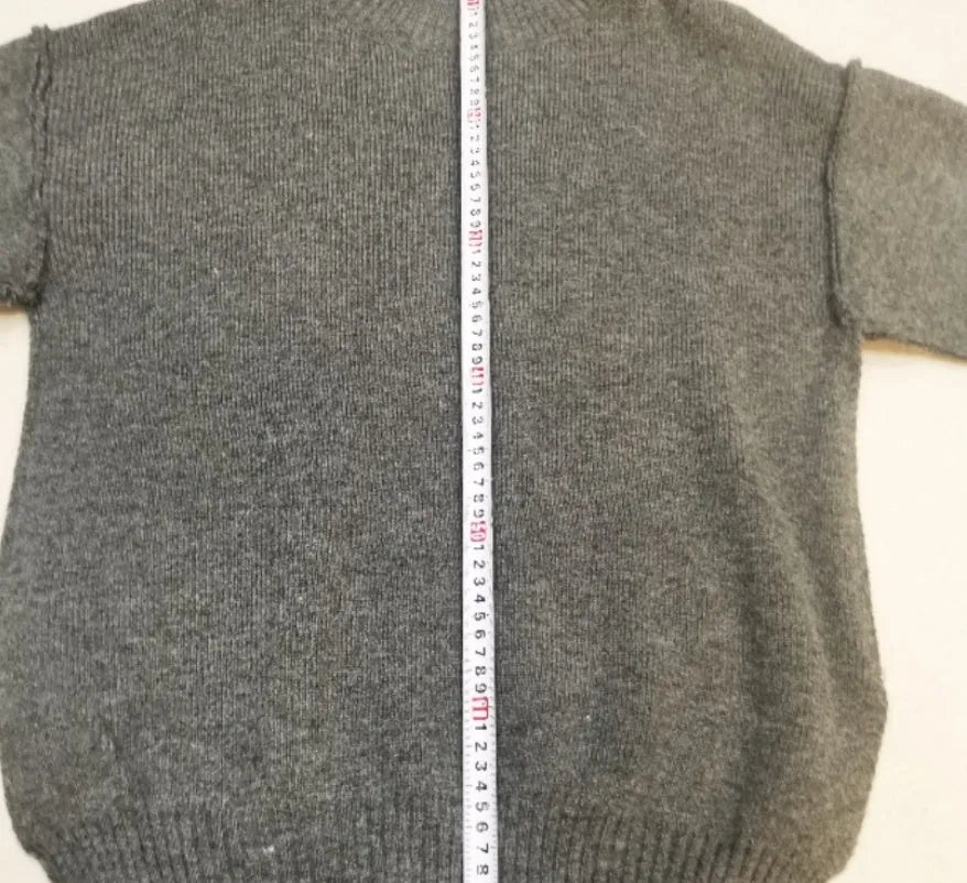 Women's acrylic knit sweater suit with side-slit top and matching trousers in dark grey