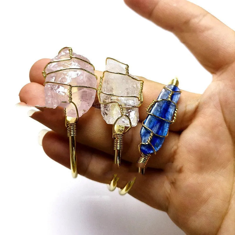 Geometric gold wire bracelet with unshaped natural rough stone crystals in bohemian style.