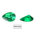 Artificial cultivated emerald gemstone in Columbia green treasure colour showing polished surface and geometric cut.