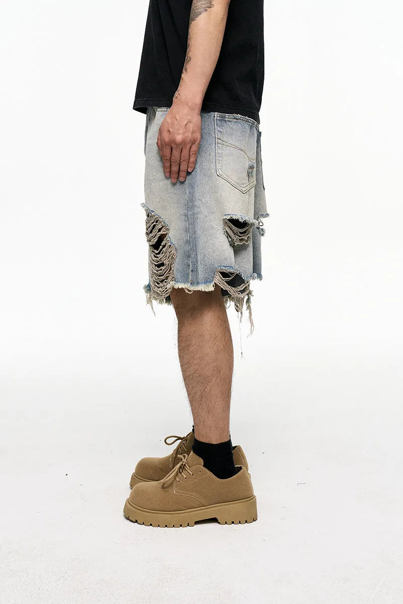 Men's light blue baggy denim shorts on a mid-waist mannequin, showing wide leg cut and zipper fly.