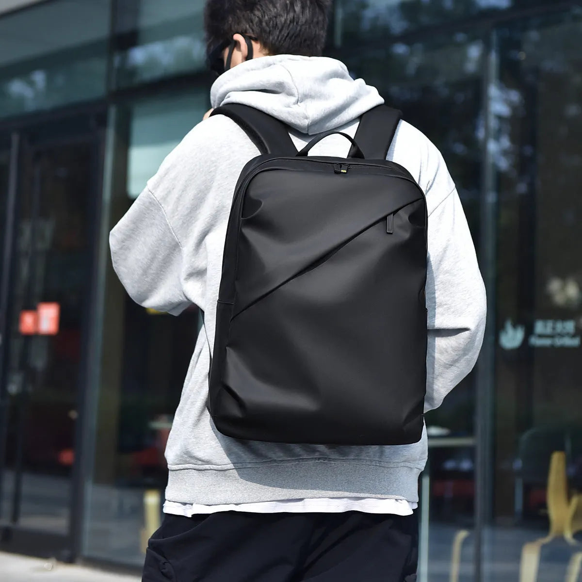 Waterproof PU leather backpack in black with contrast stitching and large capacity design