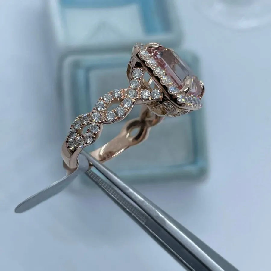 Geometric rose gold alloy ring on a plain background showing its shape and electroplated finish.