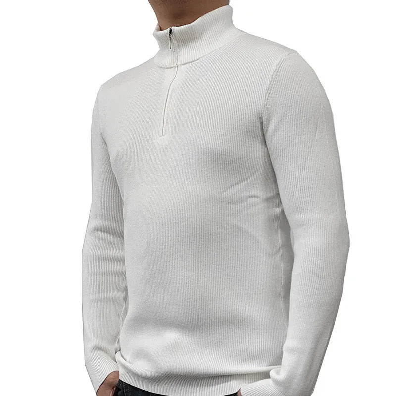 Man wearing a grey half-turtleneck zip-up sweater, showing the front zipper and long sleeves.