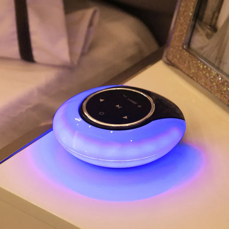 Blue and white Bluetooth speaker with integrated LED lamp showing touch controls and folding design