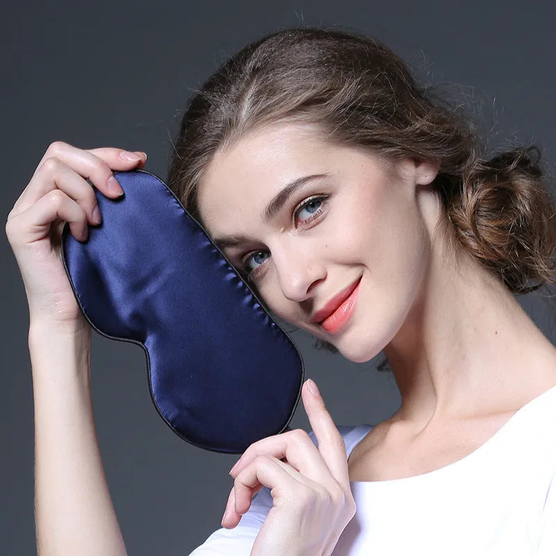 Double-sided Mulberry silk sleep eye mask showing embroidered detail, in a selection of colours on a neutral background.