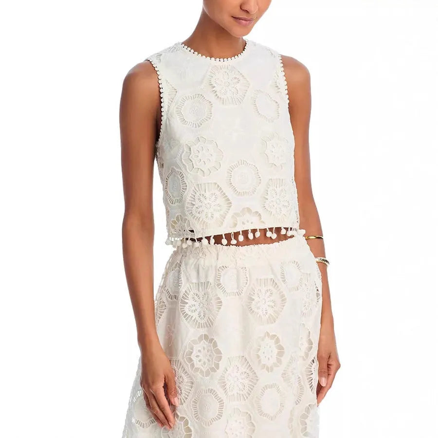 White women's retro style suit set with sleeveless top and embroidered long skirt.