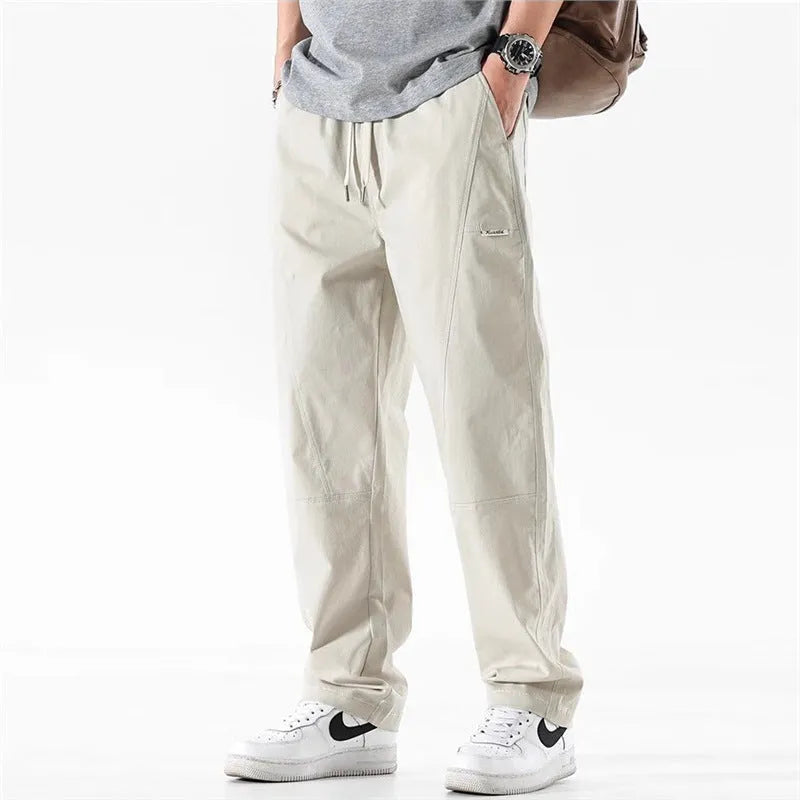 Milky white cotton wide-leg casual trousers with an elasticated waistband laid flat.