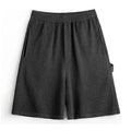 American-style heavy grey straight-leg sports shorts with elastic waistband on a solid background