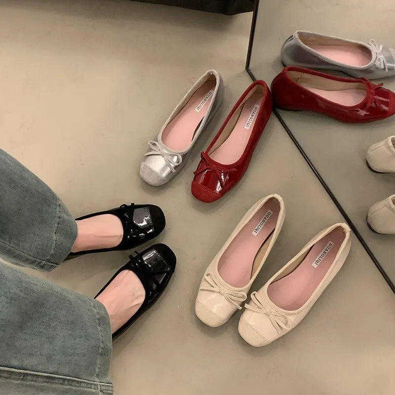 Women's wine red Mary Jane flats with square toe, decorative bow, and a low rubber sole.