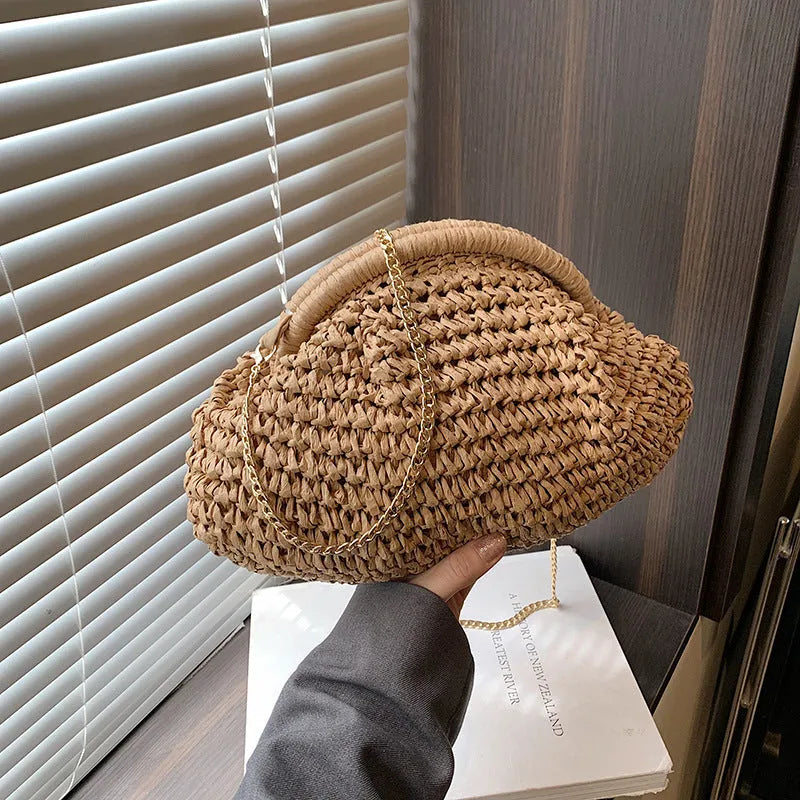 Women's straw handbag with shell shape, chain detail, and khaki colour option