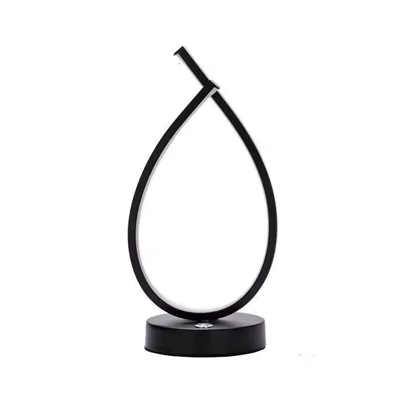 Black and white drop-shaped USB bedside table lamp with touch or switch control.
