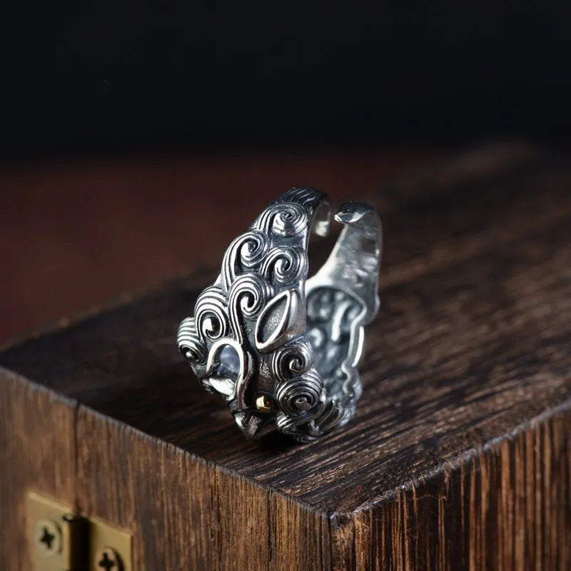 Sterling silver open ring with a detailed domineering jibeast animal and zodiac pattern.