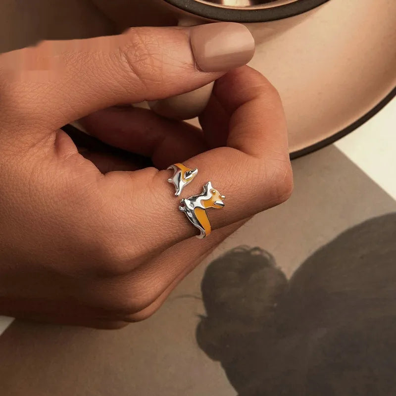 Silver corgi pet ring on a finger, showing cartoon animal design and adjustable band.