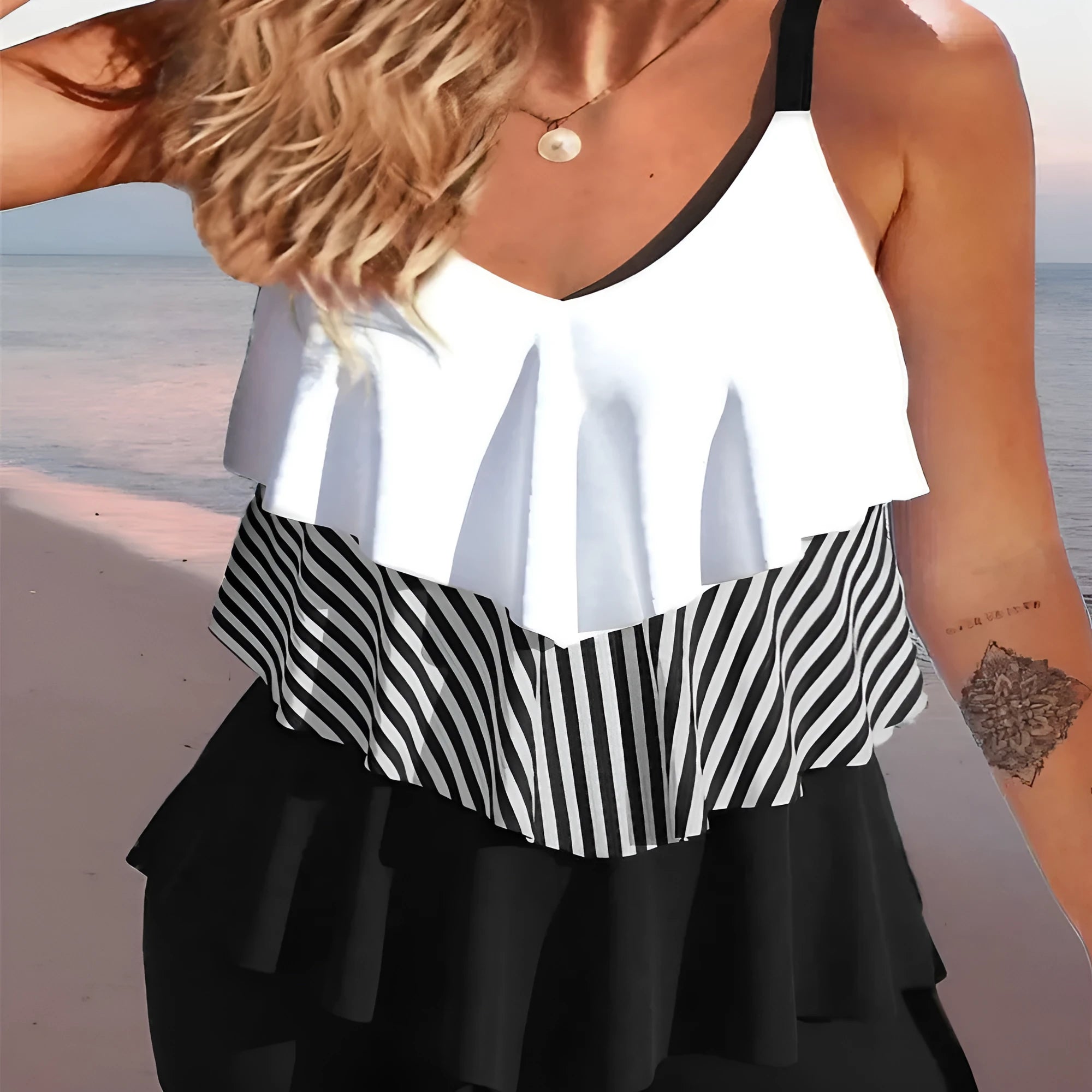 Women's backless bikini swimsuit with spaghetti straps and ruffle detail in a choice of patterns.