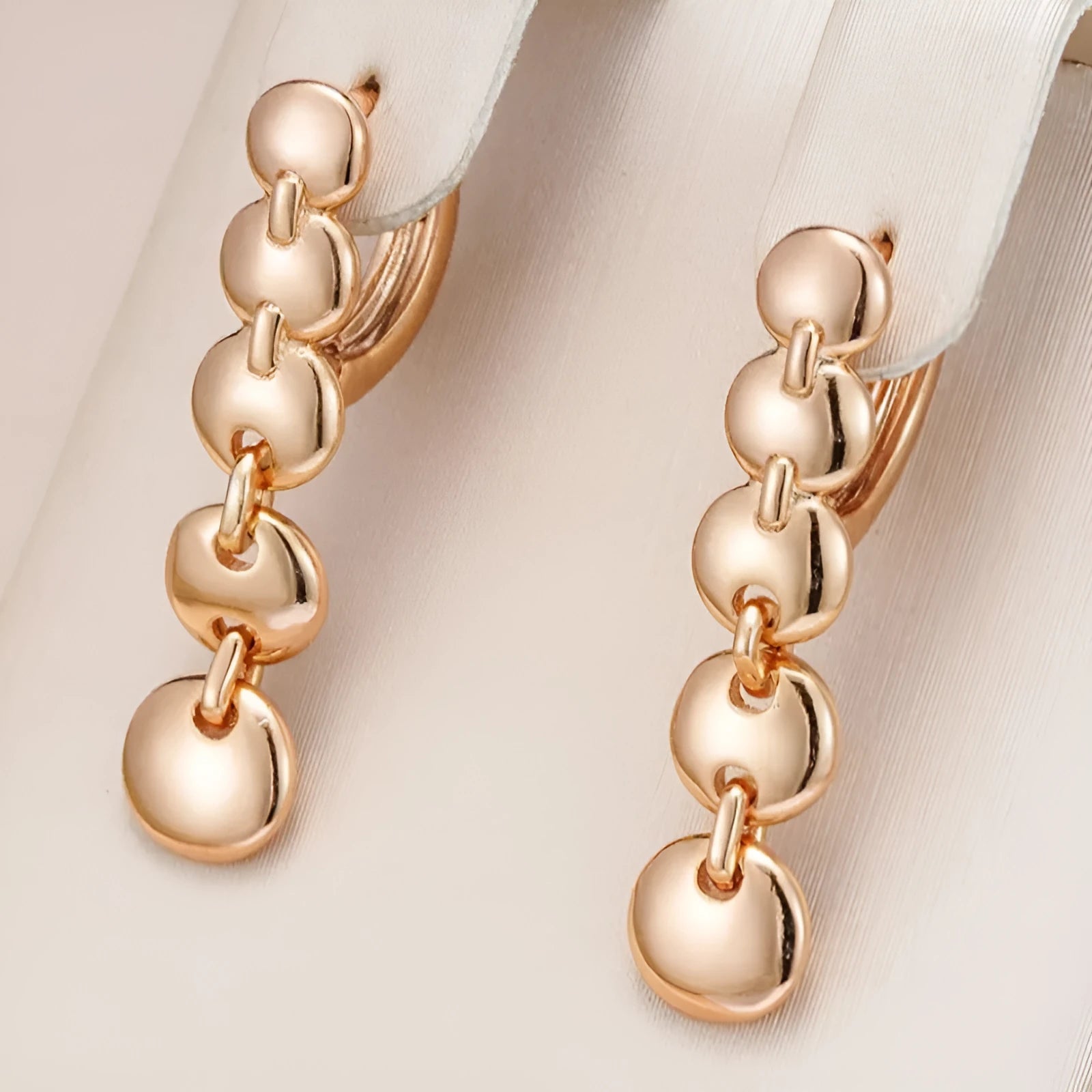 A pair of gold-coloured retro long round circle earrings with a woven texture, made from copper.