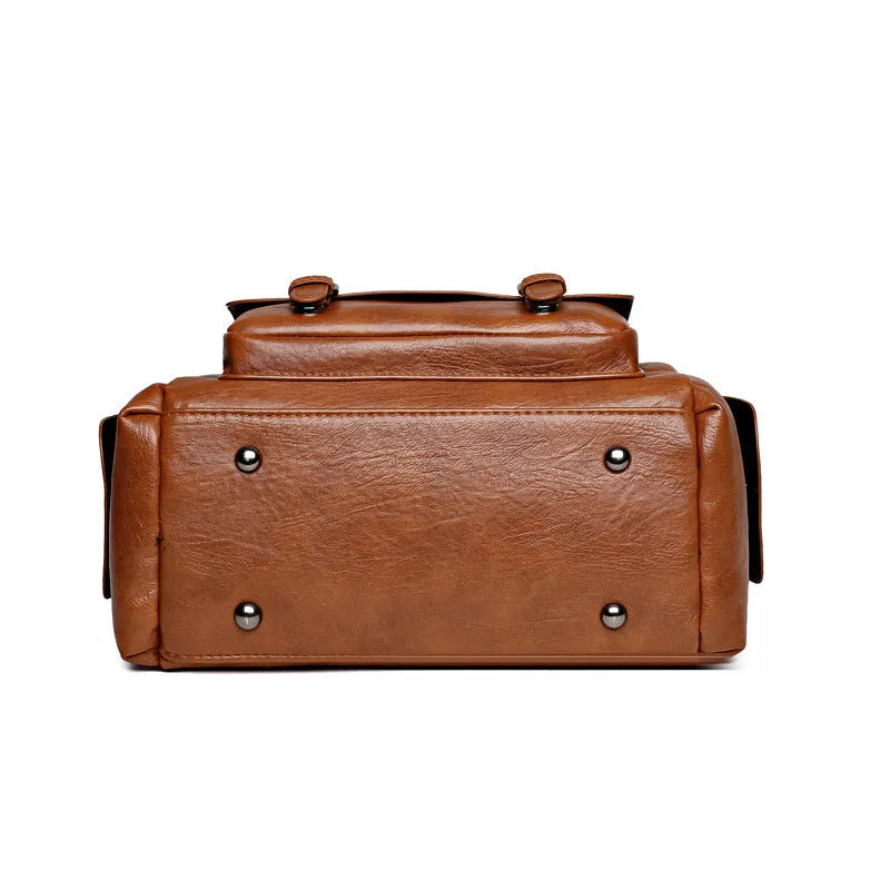 Vintage style large capacity square messenger bag in PU leather with contrast stitching.