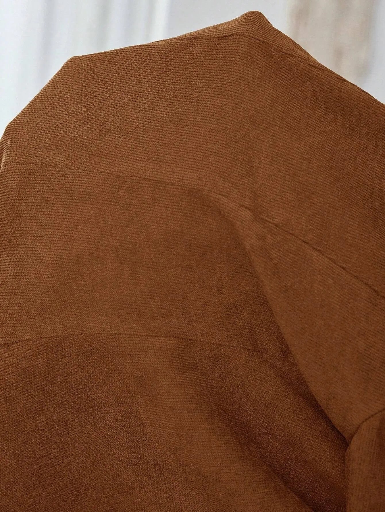 Brown men's single-breasted suit jacket with lapel collar and long sleeves.