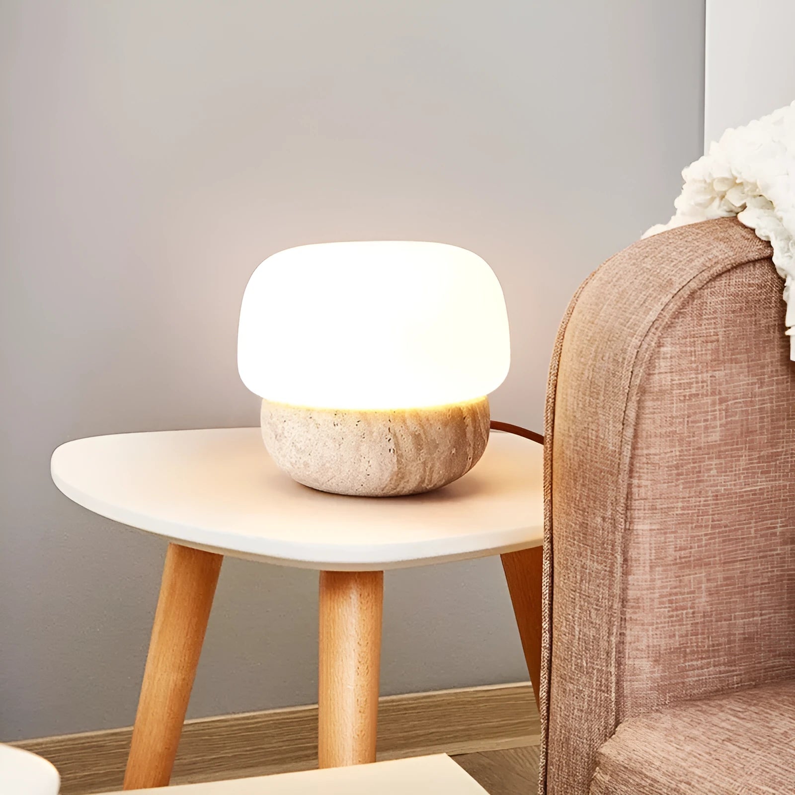Cream coloured retro bedside lamp with button switch on small table