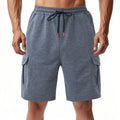 Men's loose-fit light grey cargo shorts with multiple pockets made from a towel terry fabric.