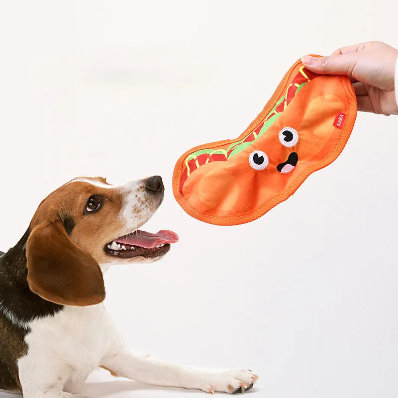 Food-shaped dog chew toys including a hamburger, fries, a hot dog, and a pizza, designed for interactive play with crinkle and squeak sounds.