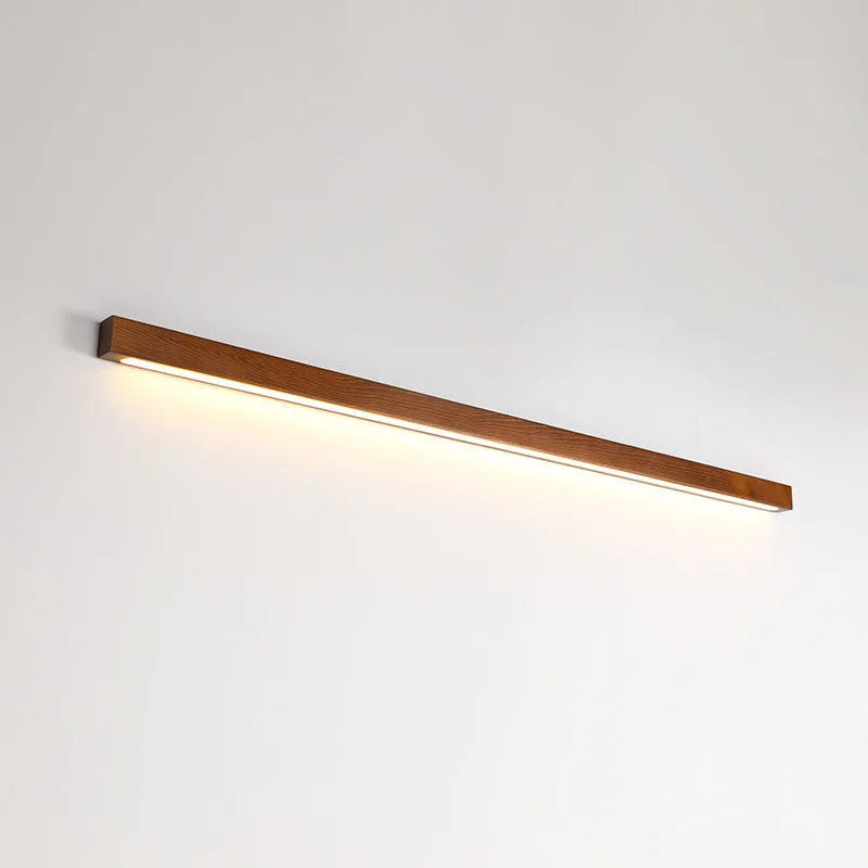 Modern walnut colour wood and acrylic wall lamp with LED lighting in minimalist log strip design