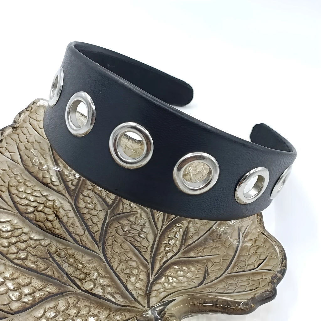 Black faux leather wide version women's headband with round, square, and dotted rivets