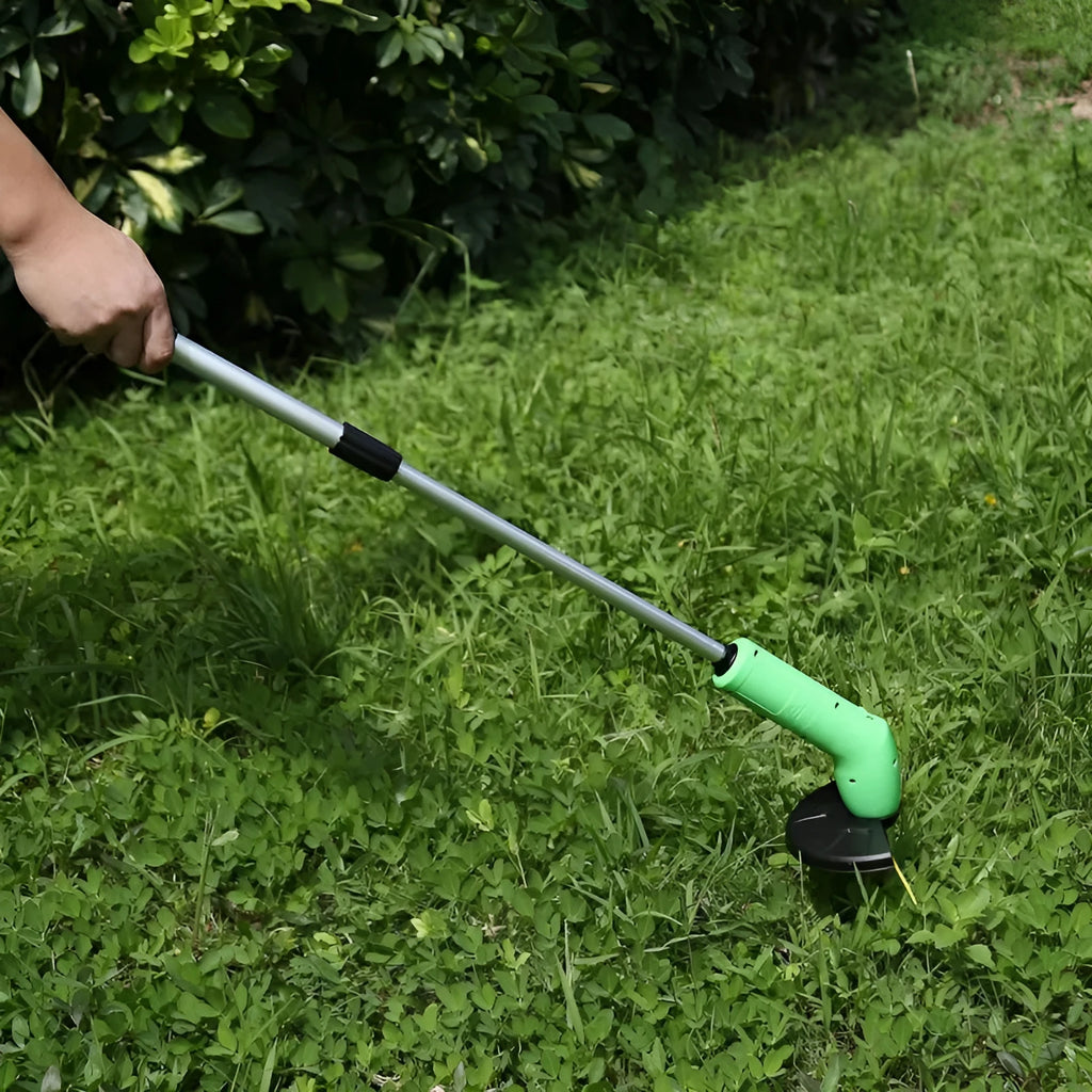 Cordless Zip Trim lawn trimmer with extension pole and protective shield on a garden lawn