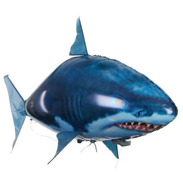 Large remote control inflatable shark balloon toy floating indoors with remote controller.