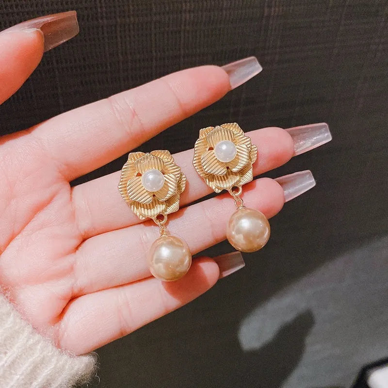 Gold-coloured floral stud earrings with a detailed needle rose pearl and opal stone design.