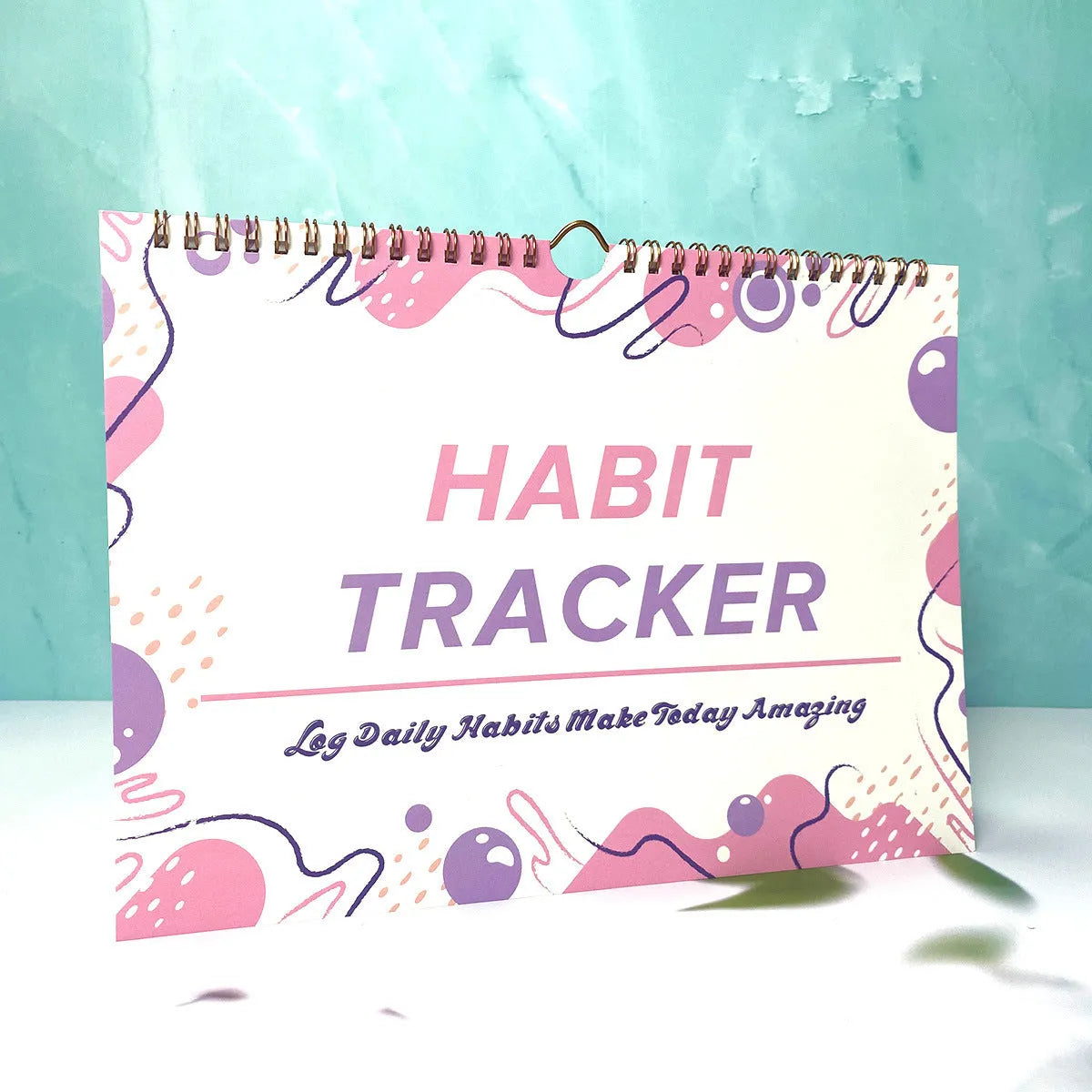 A4 habit tracking journal open showing 12 internal pages for schedule planning