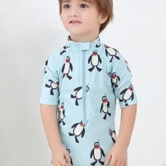 Boy's penguin print long sleeve one-piece swimsuit with matching swimming cap.