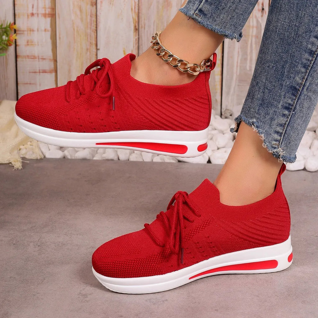 Women's low-top red casual sneakers with round toe and lace-up front on a white background.