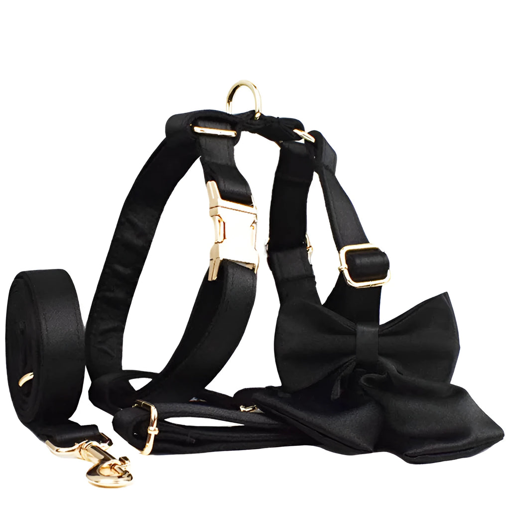 Cloth dog collar, leash, harness vest, and decorative bow set shown together in packaging.