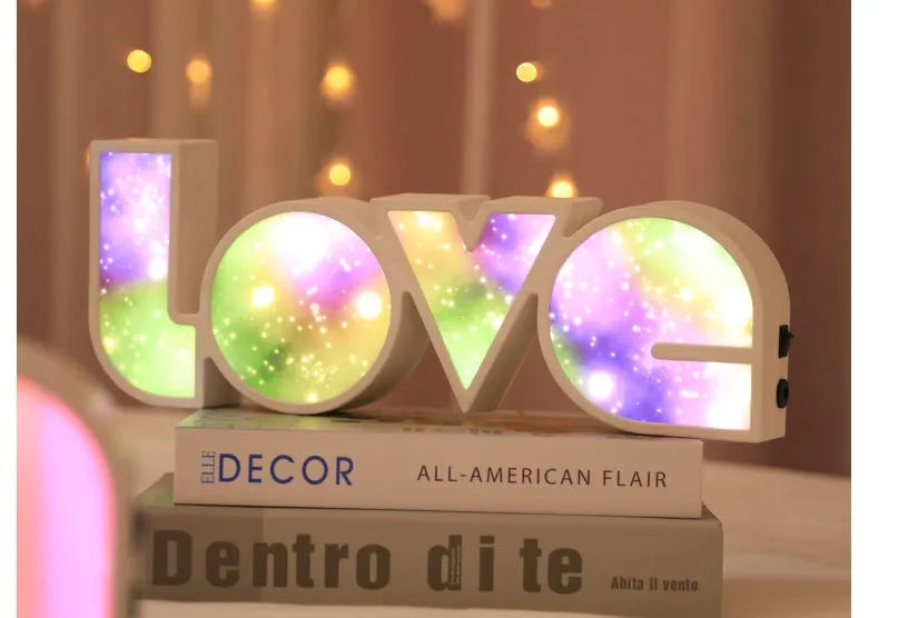 LED LOVE light with rainbow shade measuring 35.5cm, glowing softly on a wooden desk for Valentine's decoration.