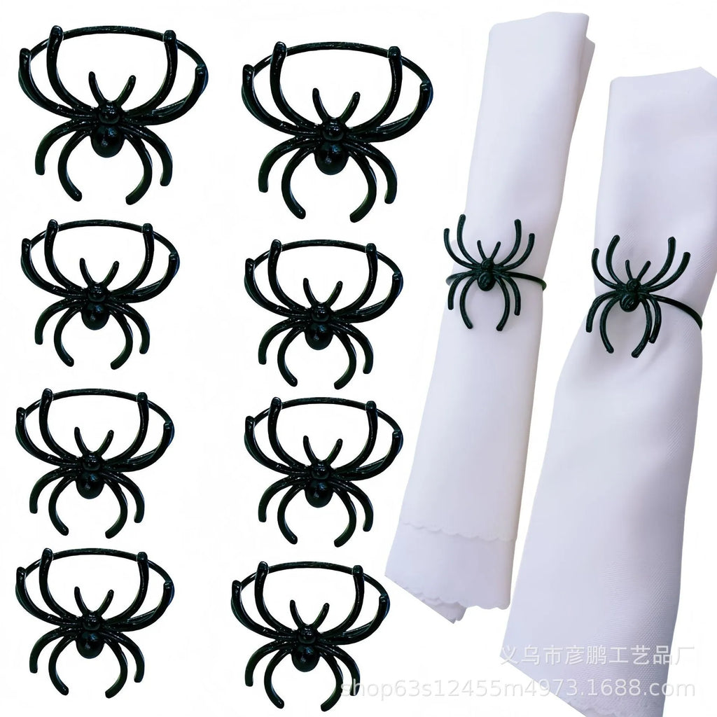 Six black alloy spider-shaped napkin rings for Halloween table decoration.